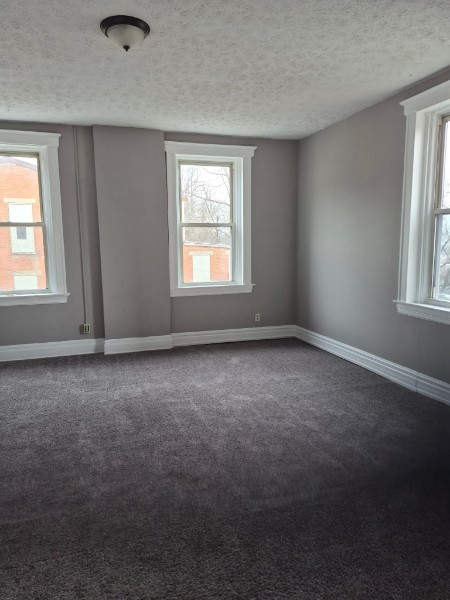 Shared living unit: bright empty room with multiple windows