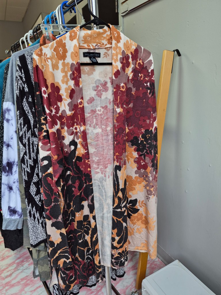 Floral cardigan displayed in the closet